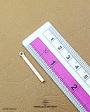 The dimensions of the 'Golden Metal Hanging Button MB710' are determined using a ruler.