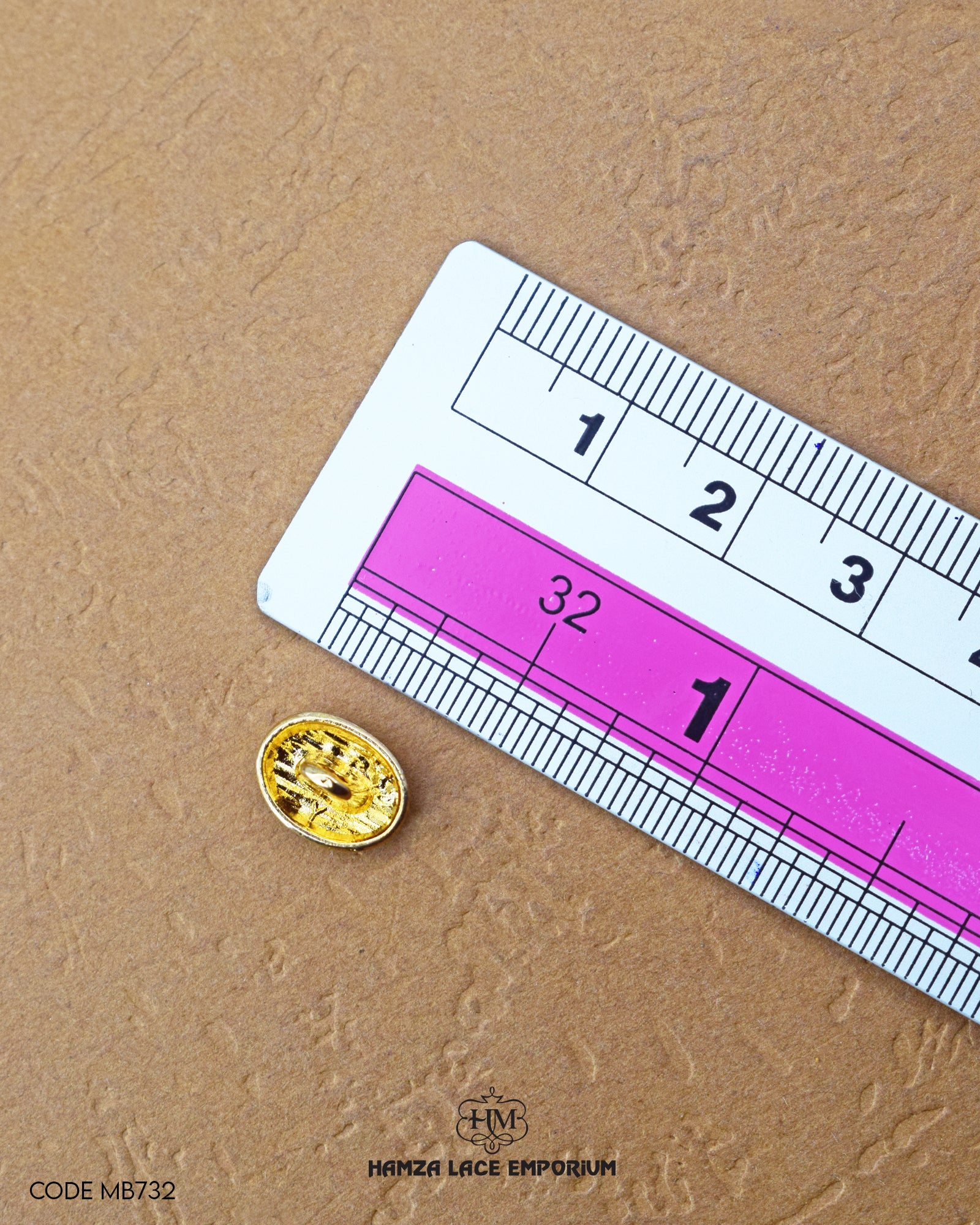 The size of the 'Golden Metal Button MB732' is measured using a ruler.