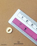 The dimensions of the 'Golden Metal Button MB751' are determined using a ruler.