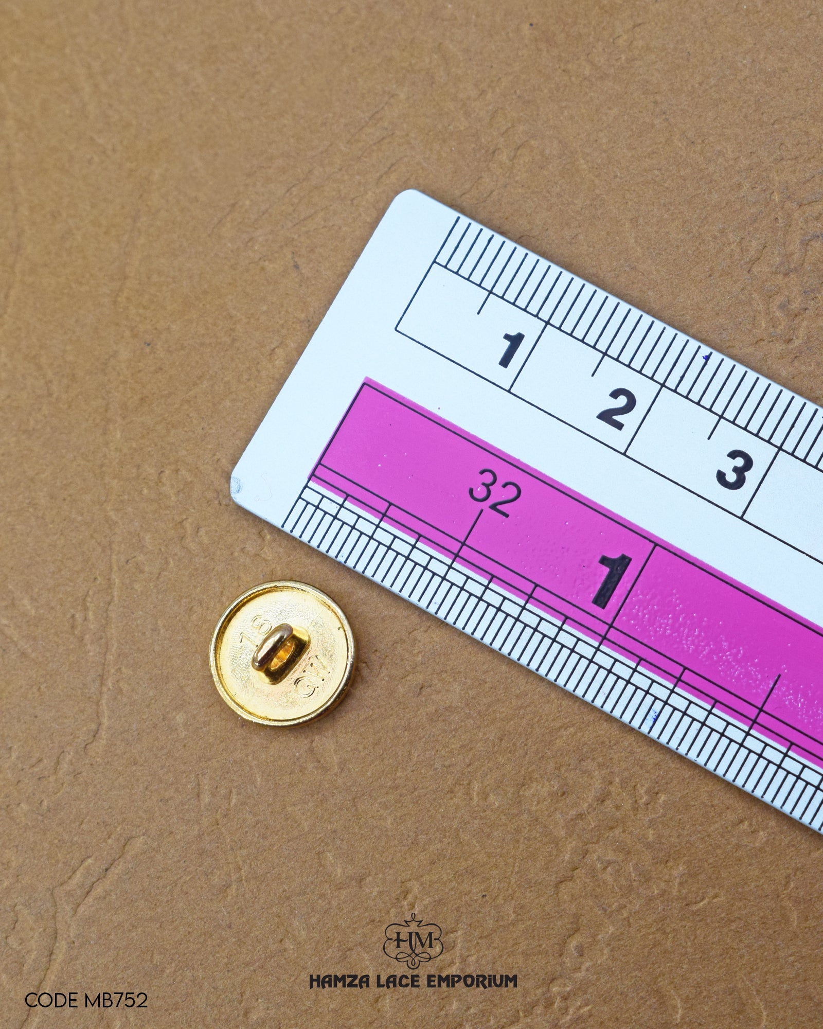 The dimensions of the 'Golden Metal Button MB752' are determined using a ruler.