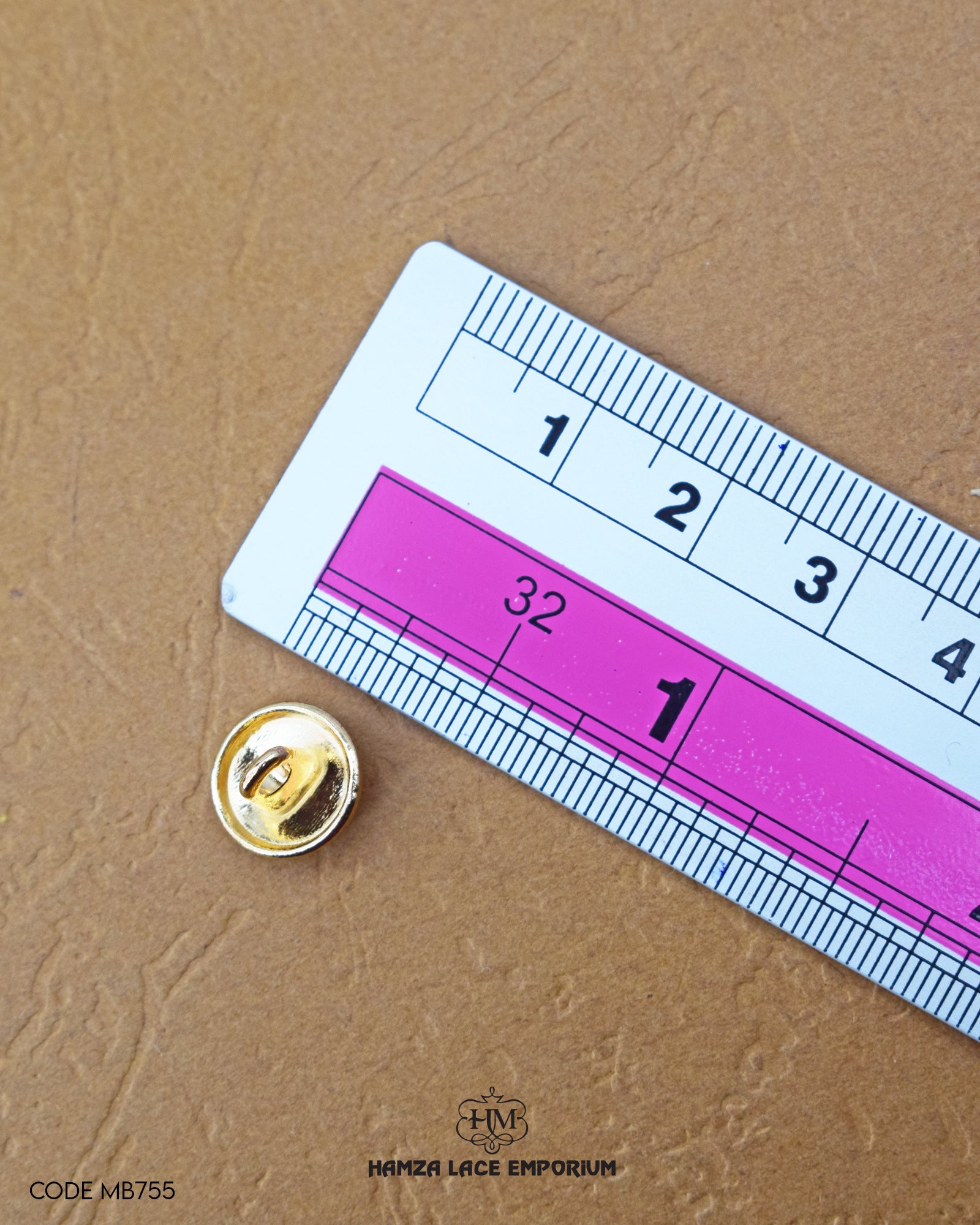 The size of the 'Golden Metal Button MB755' is measured by using a ruler