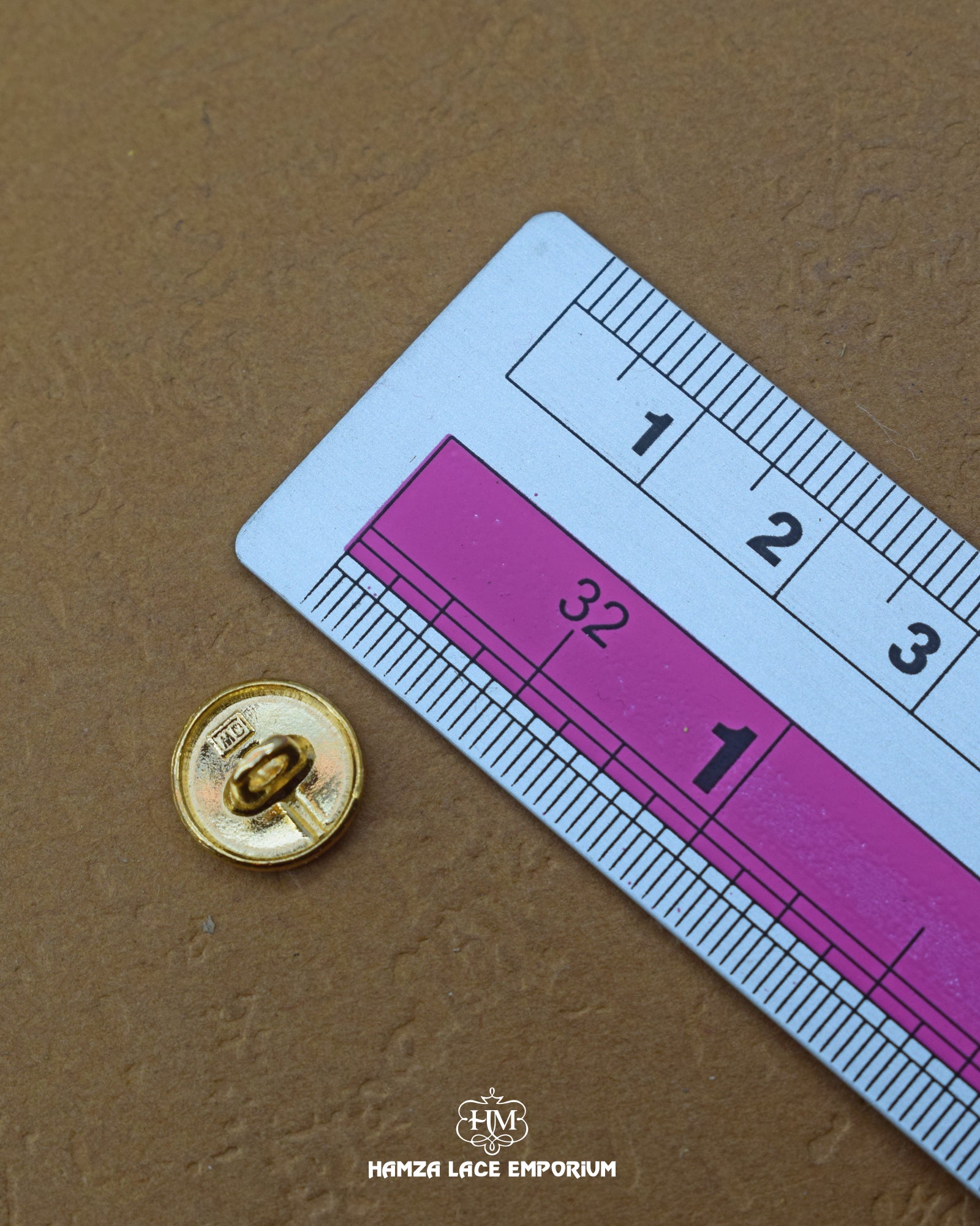 The size of the 'Golden Metal Button MB764' is measured using a ruler