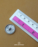 The dimensions of the 'Tie Design Button MB796' are determined using a ruler.