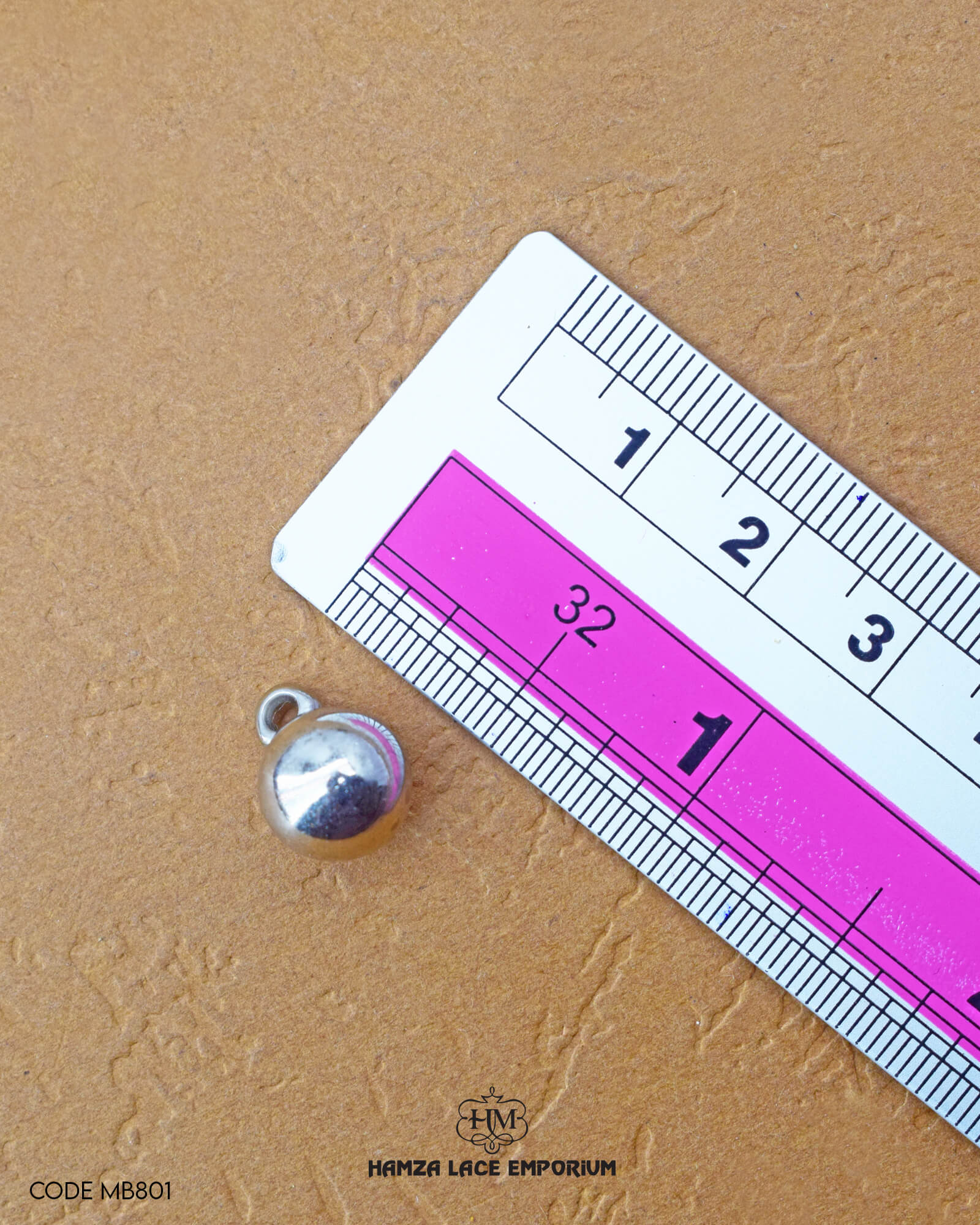 The size of the 'Plane Plastic Button MB801' is measured using a ruler.