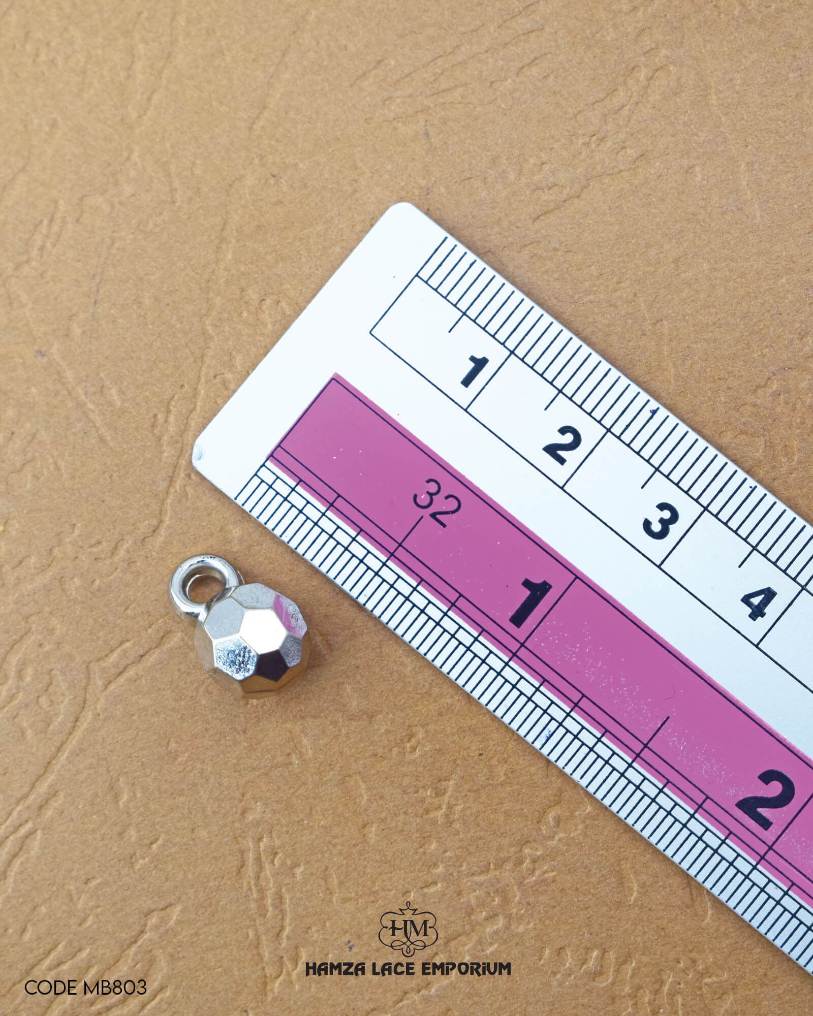 The size of the 'Loop shape Plastic Button MB803' is measured using a ruler.
