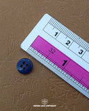 The dimensions of the 'Blue Button Plastic MB824' are determined using a ruler.