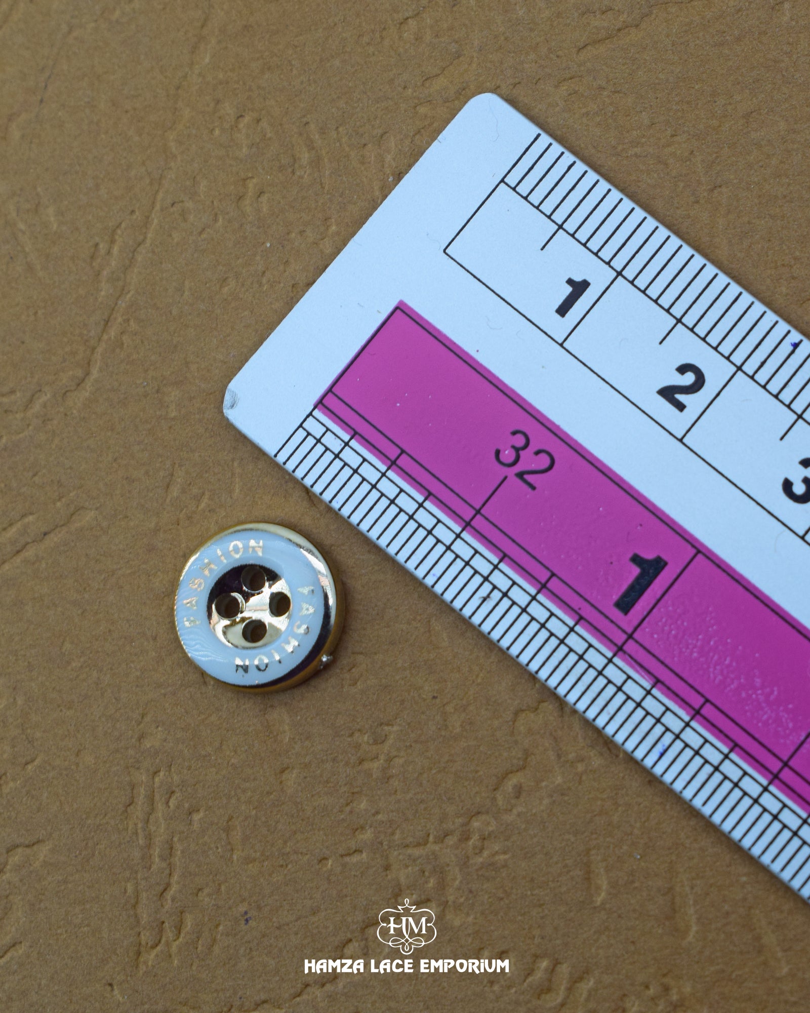 The dimensions of the 'Four Hole Plastic Button MB828' are determined using a ruler.