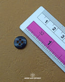 The dimensions of the 'Four Hole Plastic Button MB829 Media 2 of 2' are determined using a ruler.