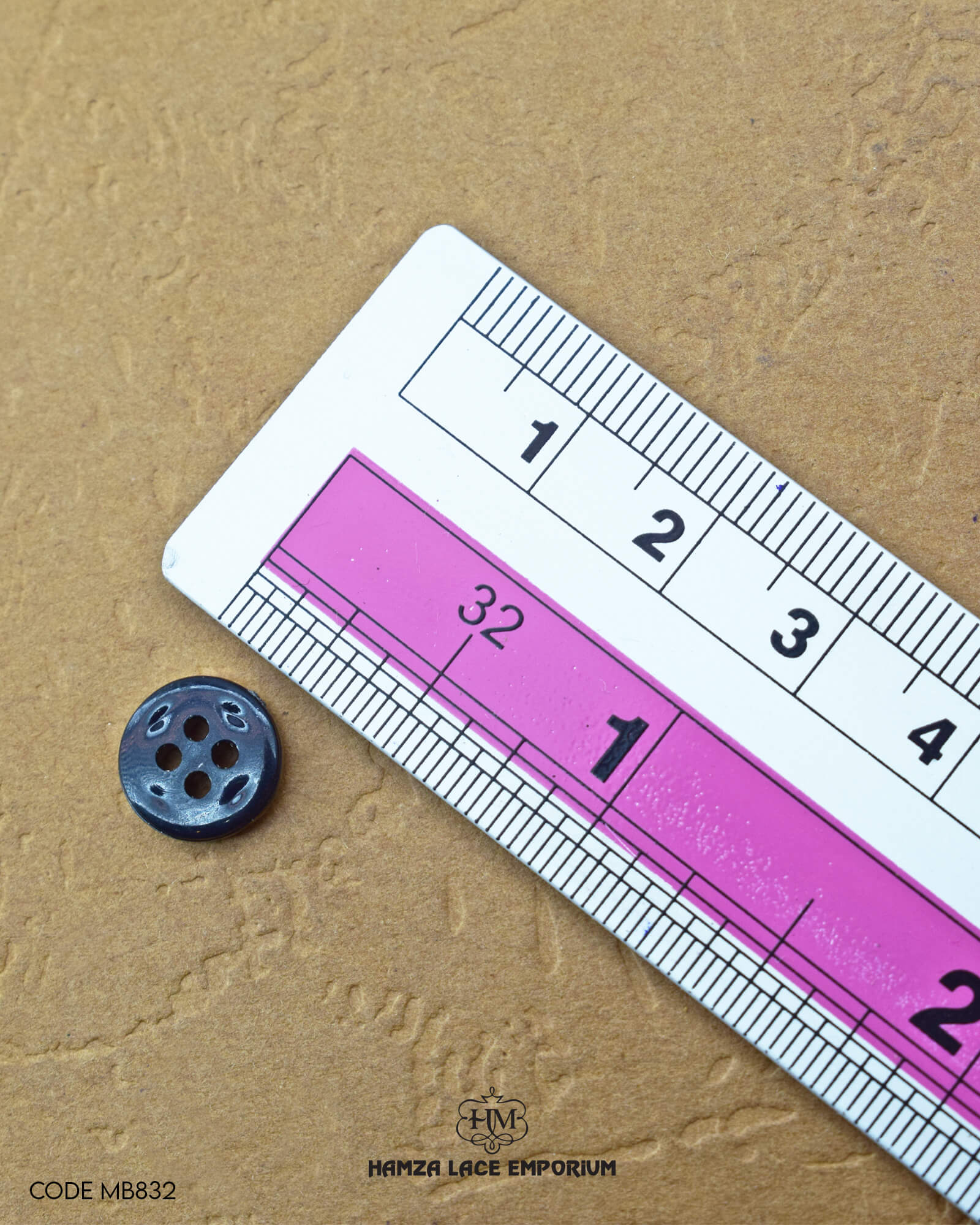 The dimensions of the 'Golden Metal Button MB832' are determined using a ruler.