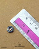 The dimensions of the 'Plastic Button MB833' are determined using a ruler.