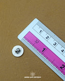 The size of the 'Plastic Button MB840' is measured using a ruler.