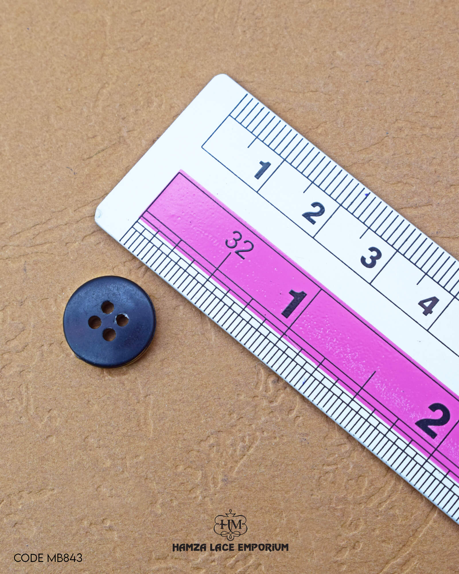 The dimensions of the 'Four Hole Golden Metal Button' are determined using a ruler.