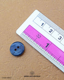 The dimensions of the 'Two Hole Button MB847' are determined using a ruler.