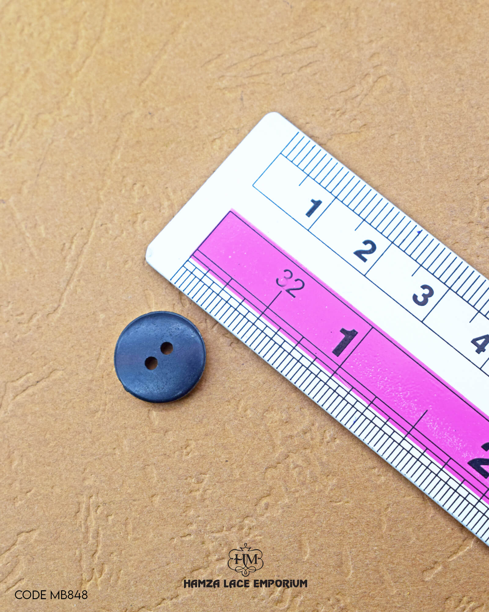 The dimensions of the 'Flower Design Button MB848' are determined using a ruler.