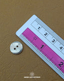 The dimensions of the 'Two Hole Plastic Button MB851' are determined using a ruler.