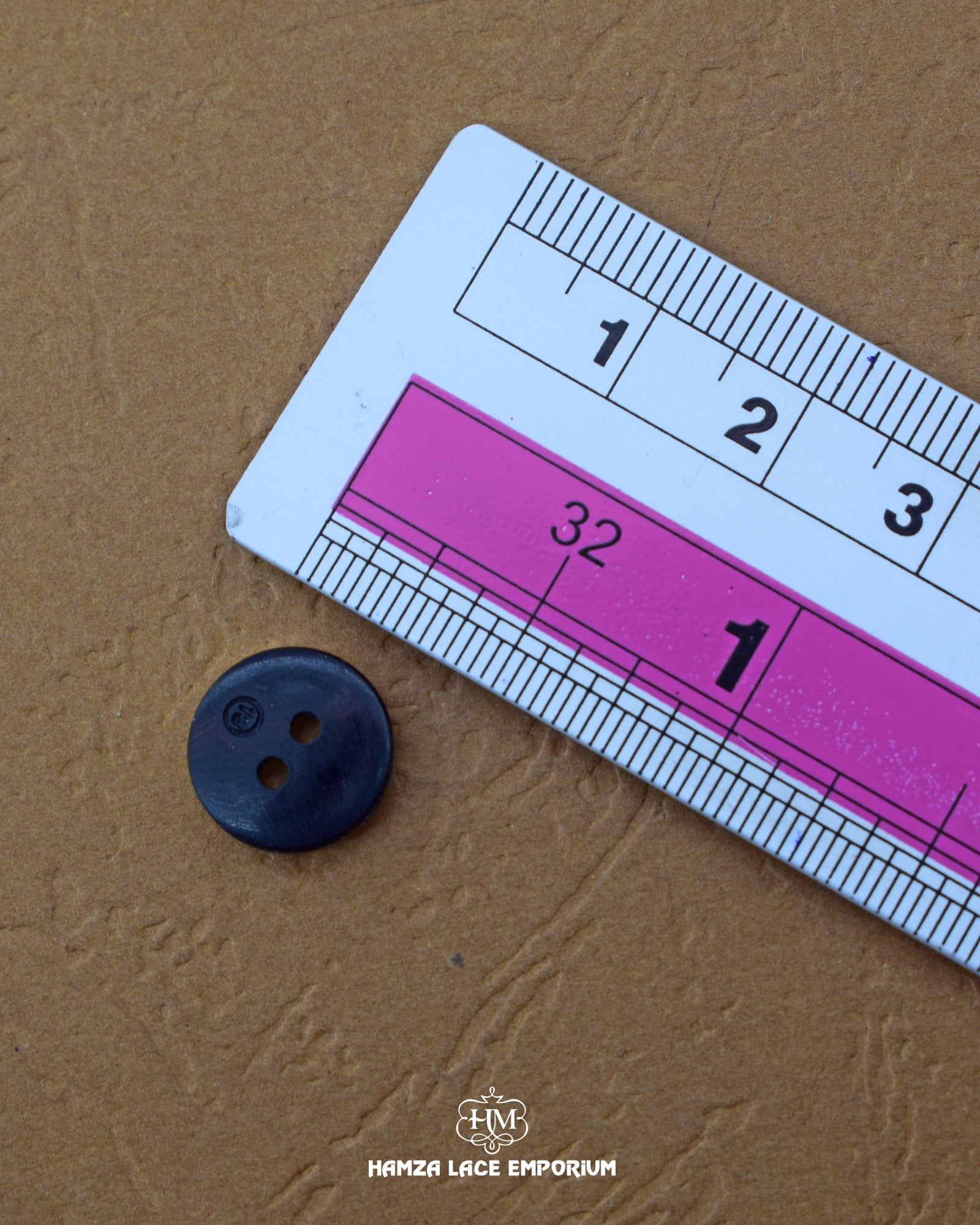 Size of the 'Round Shape Plastic Button MB853' is given with the help of a ruler
