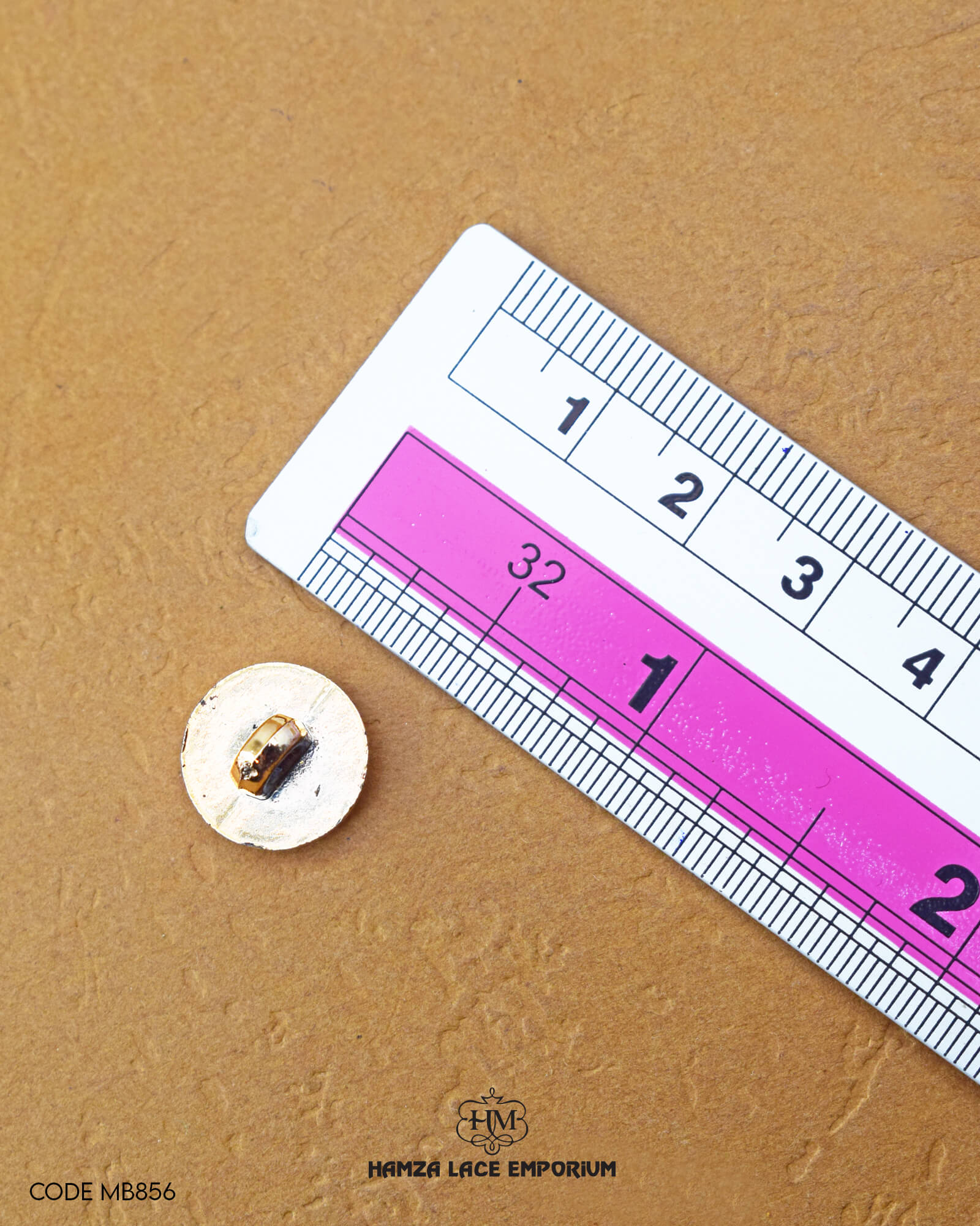 Size of the 'Metal Button MB856' is given with the help of a ruler
