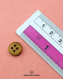 The size of the Beautifully designed 'Four Hole Wood Button WB77' is measured by using a ruler