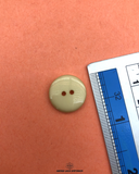 The size of the Beautifully designed 'Two Hole Plastic Button PB027' is measured by using a ruler