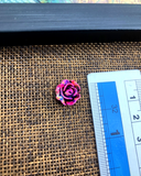 The size of the Beautifully designed 'Flower Design Plastic Button PB070' is measured by using a ruler
